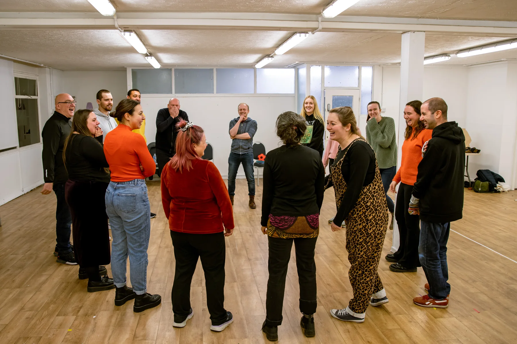 Stage Craft participants laughing together during a group acting exercise